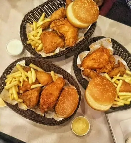 Three baskets of broast, buns, and fries.
