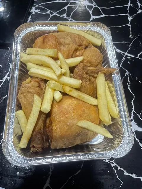 Broast and fries in a foil tray.